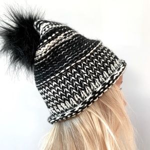 Handmade black and white knit hat with pom pom.